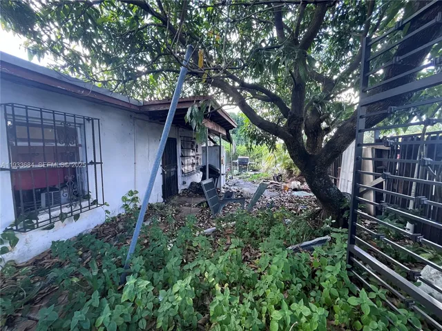 a view of a house with a tree in a yard