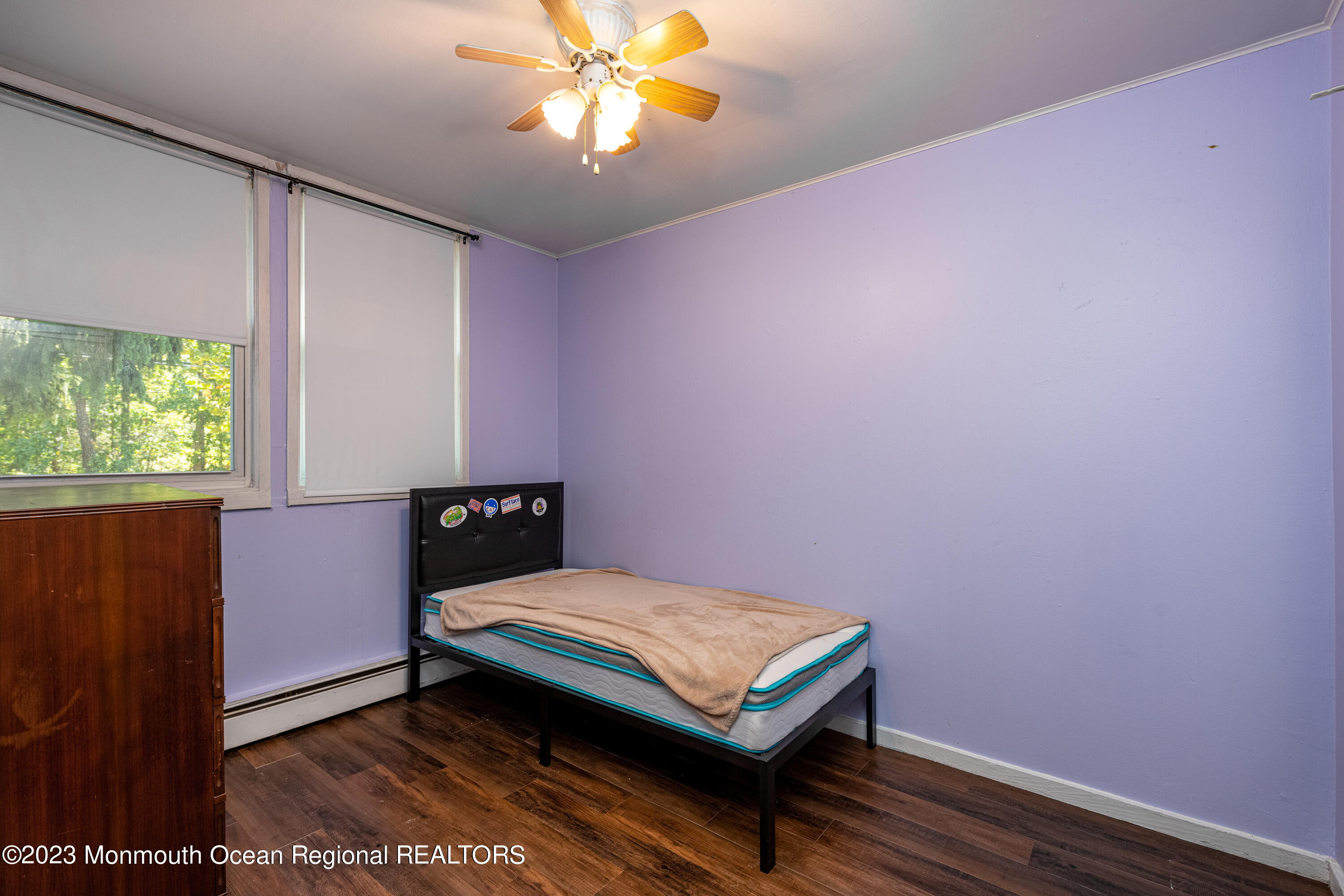 508 Georgia Tavern Road Howell, NJ 07731 - Photo 19 of 33 a bedroom with a bed and a chandelier