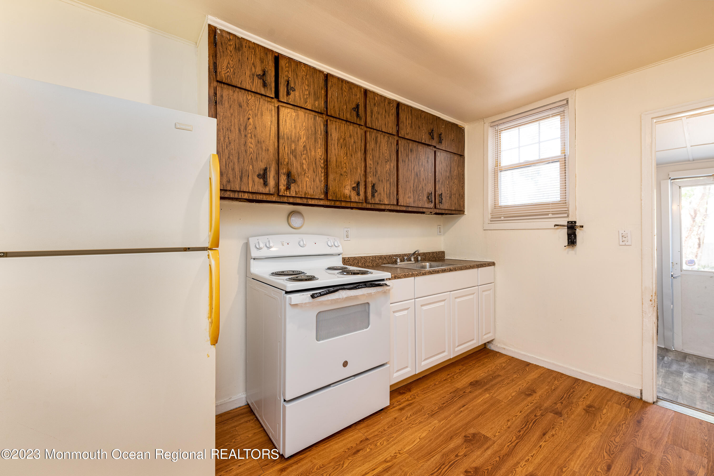 508 Georgia Tavern Road Howell, NJ 07731 - Photo 26 of 33 a kitchen with granite countertop a stove a sink and a refrigerator