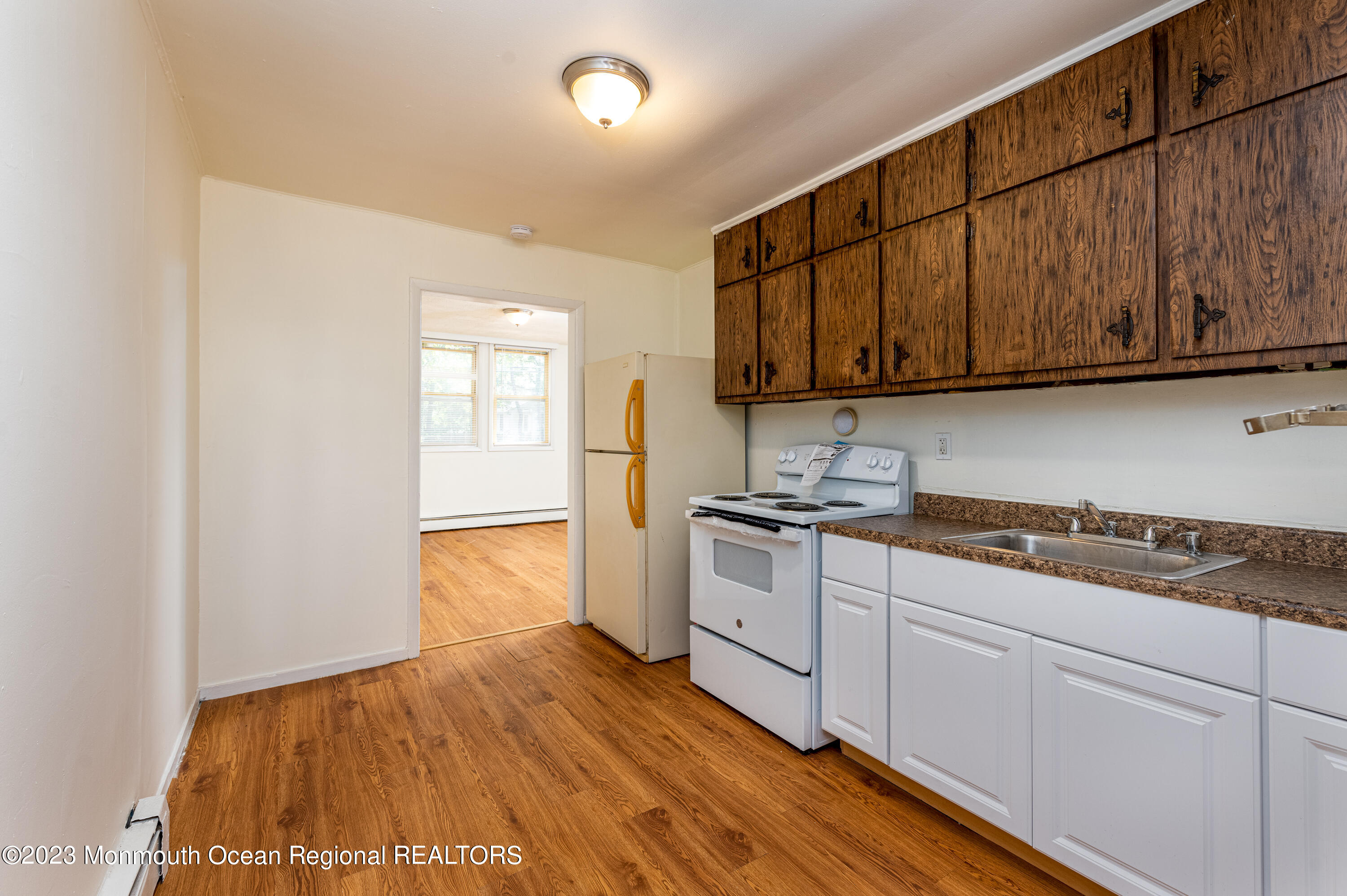 508 Georgia Tavern Road Howell, NJ 07731 - Photo 27 of 33 a kitchen with granite countertop wooden cabinets a sink and dishwasher