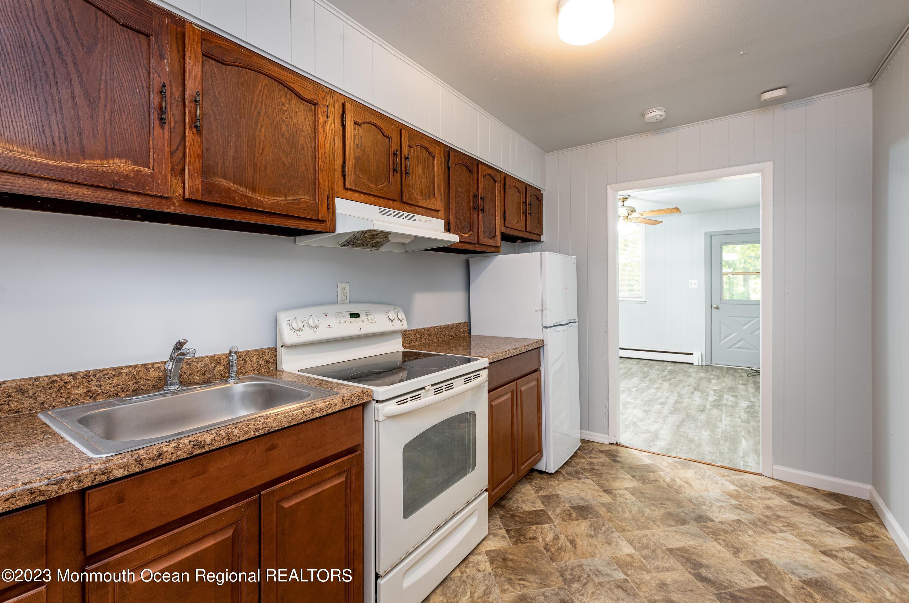 508 Georgia Tavern Road Howell, NJ 07731 - Photo 8 of 33 a kitchen with granite countertop a sink stove and cabinets