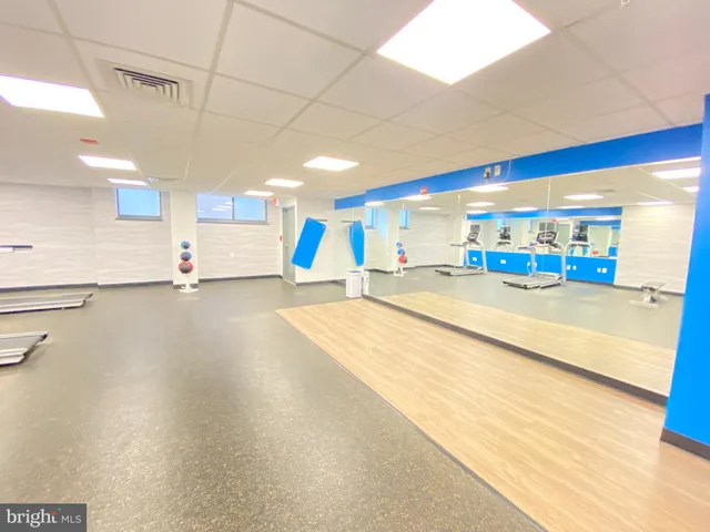 a front view of a house with a yard and potted plants