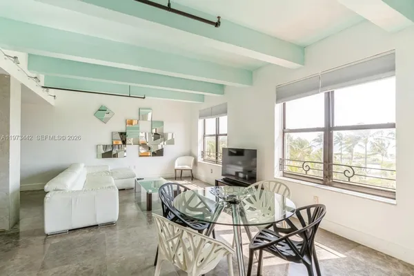 a view of a dining room with furniture window and outside view