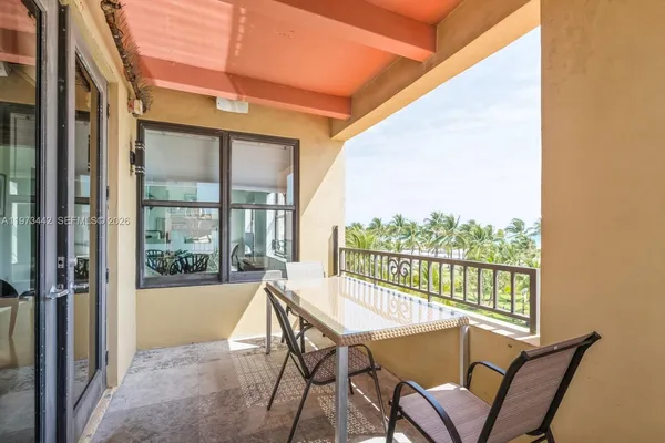 a view of a chairs and table in the balcony