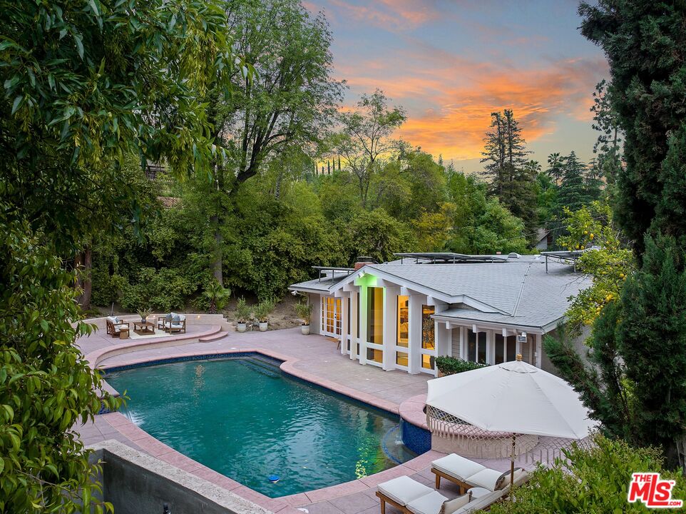 22801 Pera Road Woodland Hills, CA 91364 - Photo 1 of 46 an aerial view of a house with garden space and trees