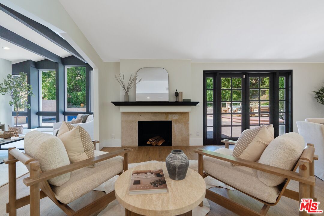 22801 Pera Road Woodland Hills, CA 91364 - Photo 11 of 46 a living room with furniture and a fireplace