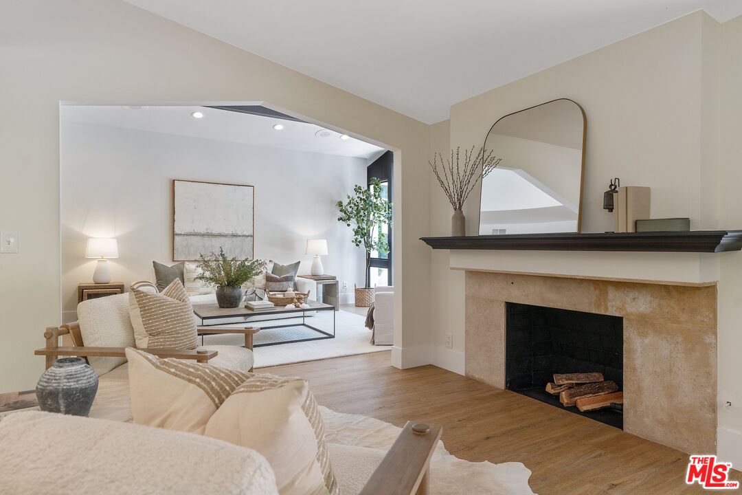 22801 Pera Road Woodland Hills, CA 91364 - Photo 12 of 46 a living room with furniture and a fireplace