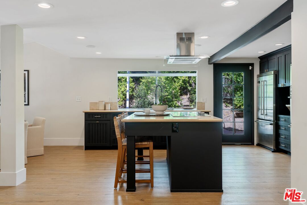 22801 Pera Road Woodland Hills, CA 91364 - Photo 16 of 46 a kitchen with a table chairs and a refrigerator