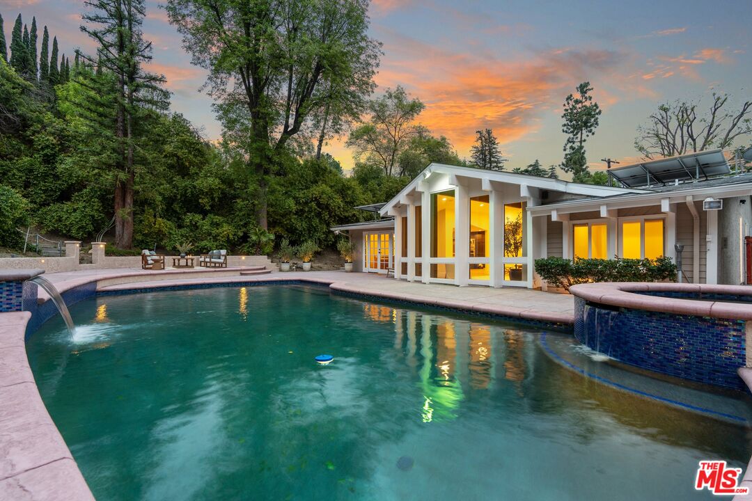 22801 Pera Road Woodland Hills, CA 91364 - Photo 2 of 46 a swimming pool view with a outdoor seating