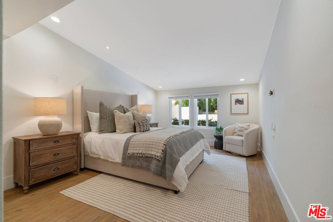 22801 Pera Road Woodland Hills, CA 91364 - Photo 22 of 46 a bedroom with a bed and lamp