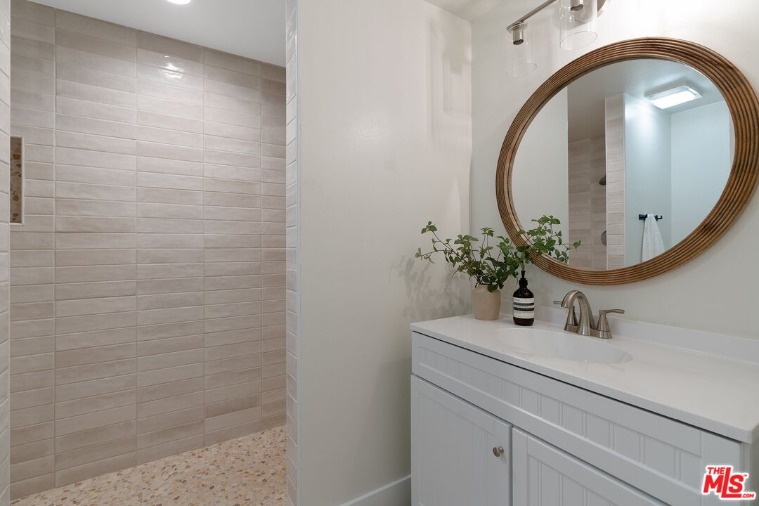 22801 Pera Road Woodland Hills, CA 91364 - Photo 27 of 46 a bathroom with a sink and a mirror