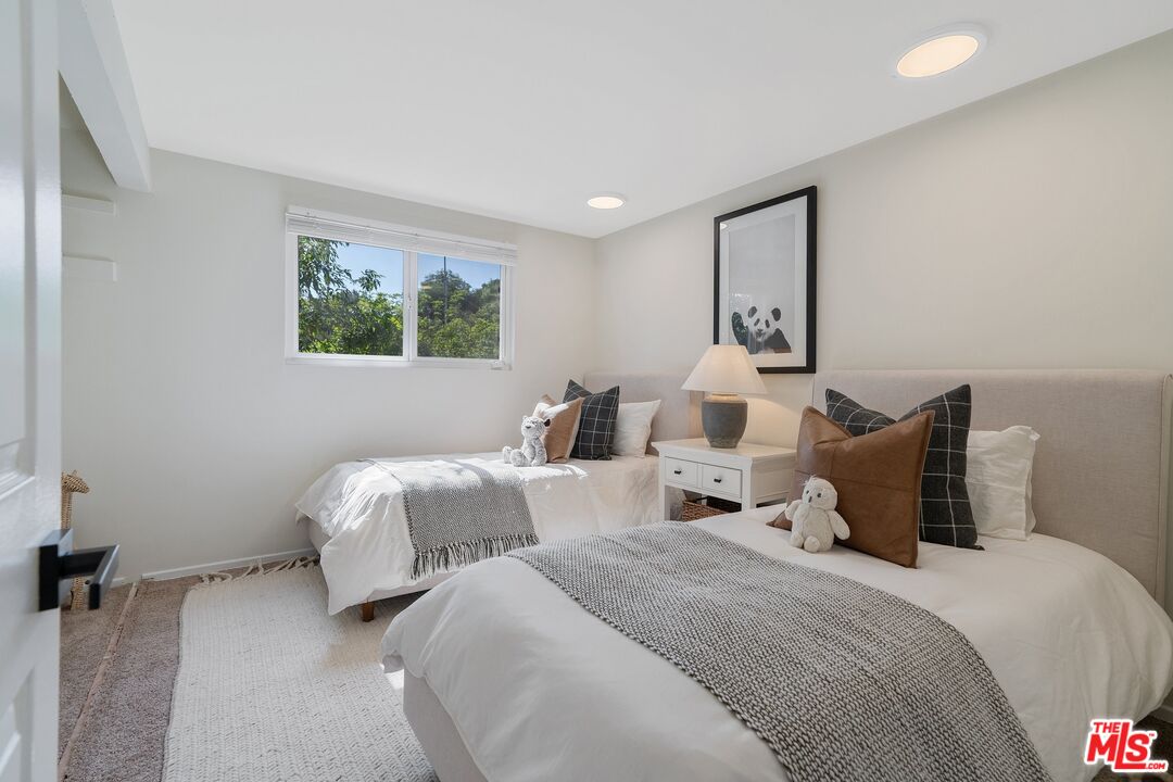 22801 Pera Road Woodland Hills, CA 91364 - Photo 28 of 46 a bedroom with two beds and painting on the wall