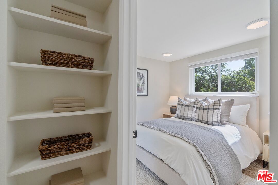 22801 Pera Road Woodland Hills, CA 91364 - Photo 30 of 46 a bedroom with a bed and a window