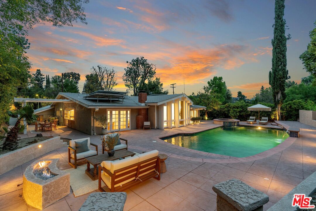 22801 Pera Road Woodland Hills, CA 91364 - Photo 3 of 46 a view of a backyard with sitting area