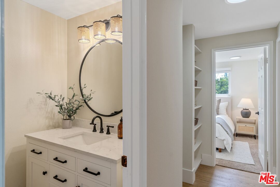 22801 Pera Road Woodland Hills, CA 91364 - Photo 31 of 46 a bathroom with a sink vanity and a mirror