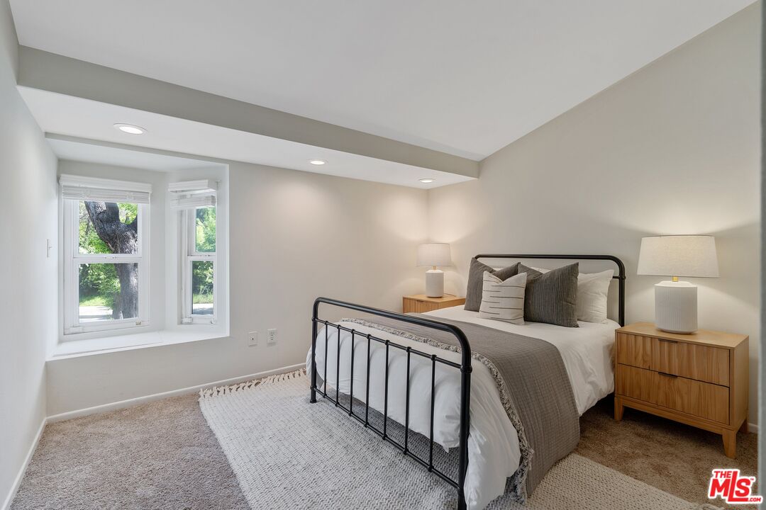 22801 Pera Road Woodland Hills, CA 91364 - Photo 32 of 46 a bedroom with a bed and a window