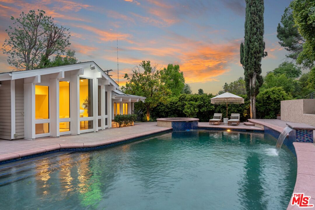 22801 Pera Road Woodland Hills, CA 91364 - Photo 35 of 46 a view of a house with swimming pool and sitting area
