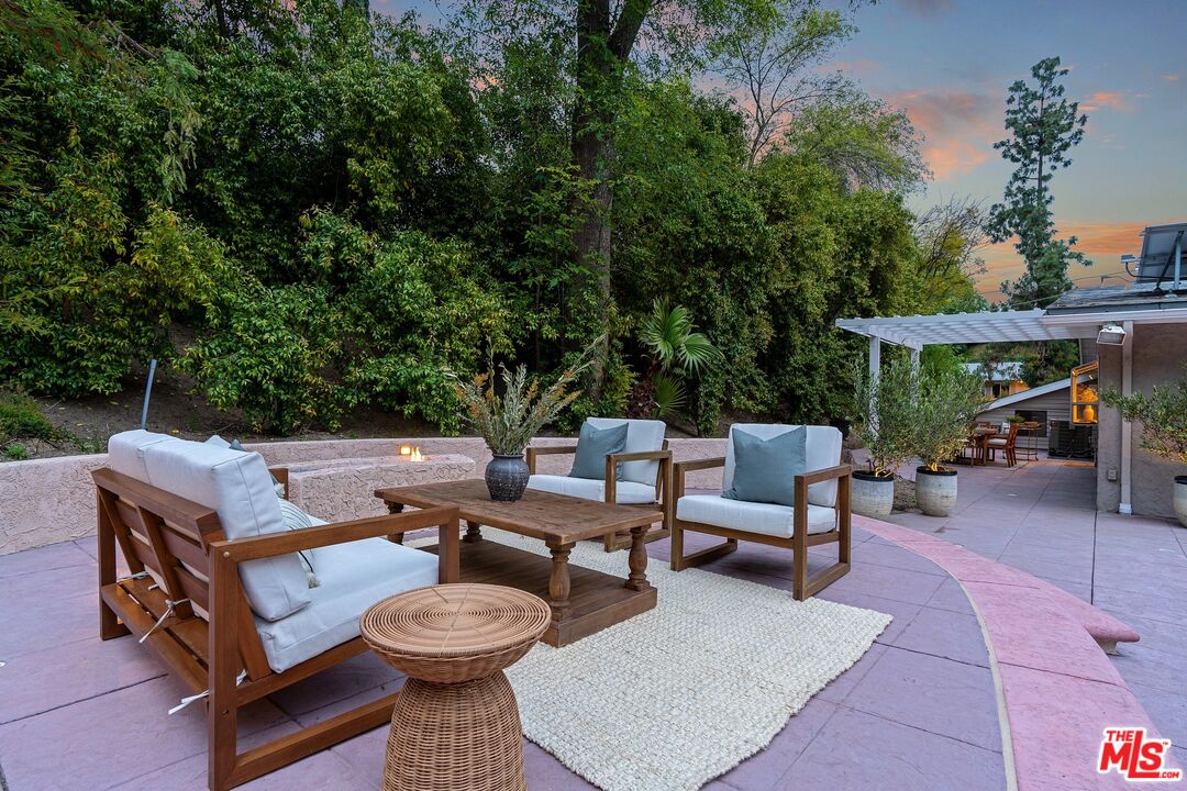 22801 Pera Road Woodland Hills, CA 91364 - Photo 37 of 46 a view of a patio with a table and chairs