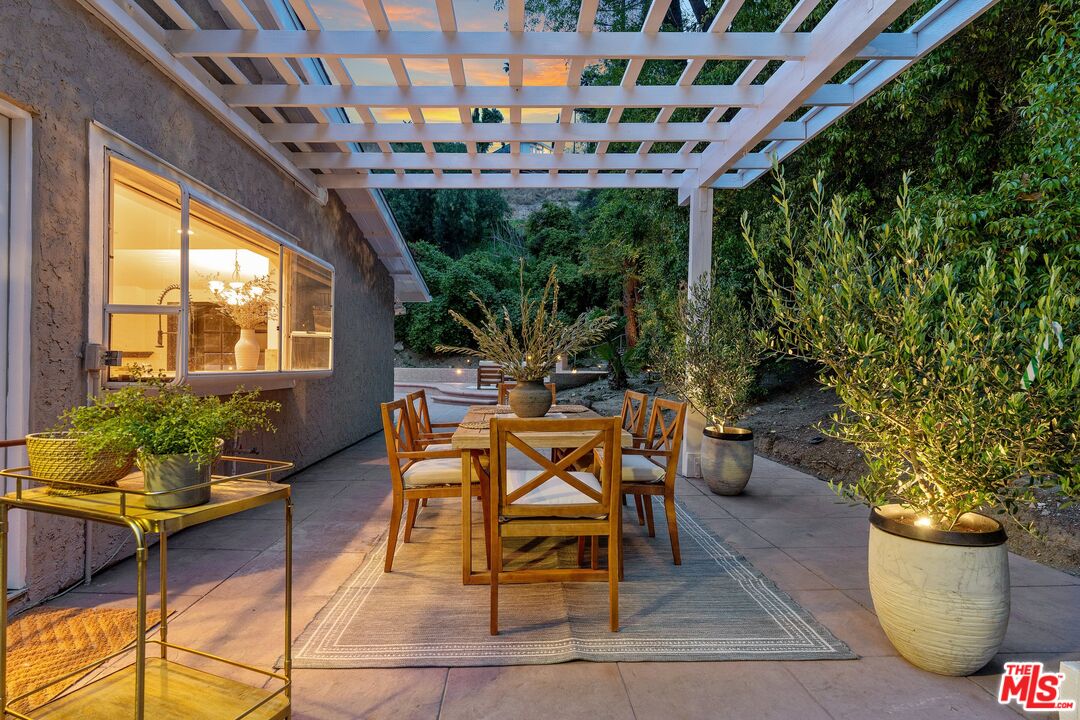 22801 Pera Road Woodland Hills, CA 91364 - Photo 40 of 46 a view of an outdoor dining space with a table and chairs