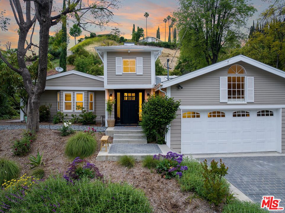 22801 Pera Road Woodland Hills, CA 91364 - Photo 4 of 46 a view of a house with backyard and garden