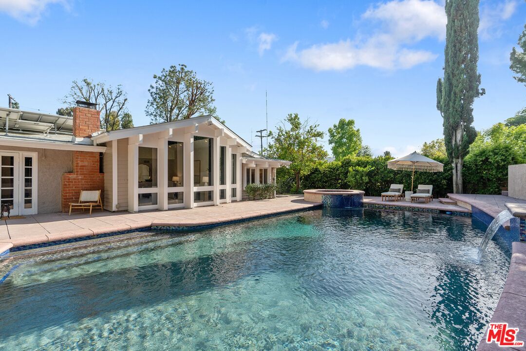 22801 Pera Road Woodland Hills, CA 91364 - Photo 41 of 46 a view of a house with backyard sitting area and garden