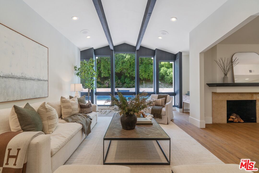 22801 Pera Road Woodland Hills, CA 91364 - Photo 5 of 46 a living room with furniture large window and fireplace