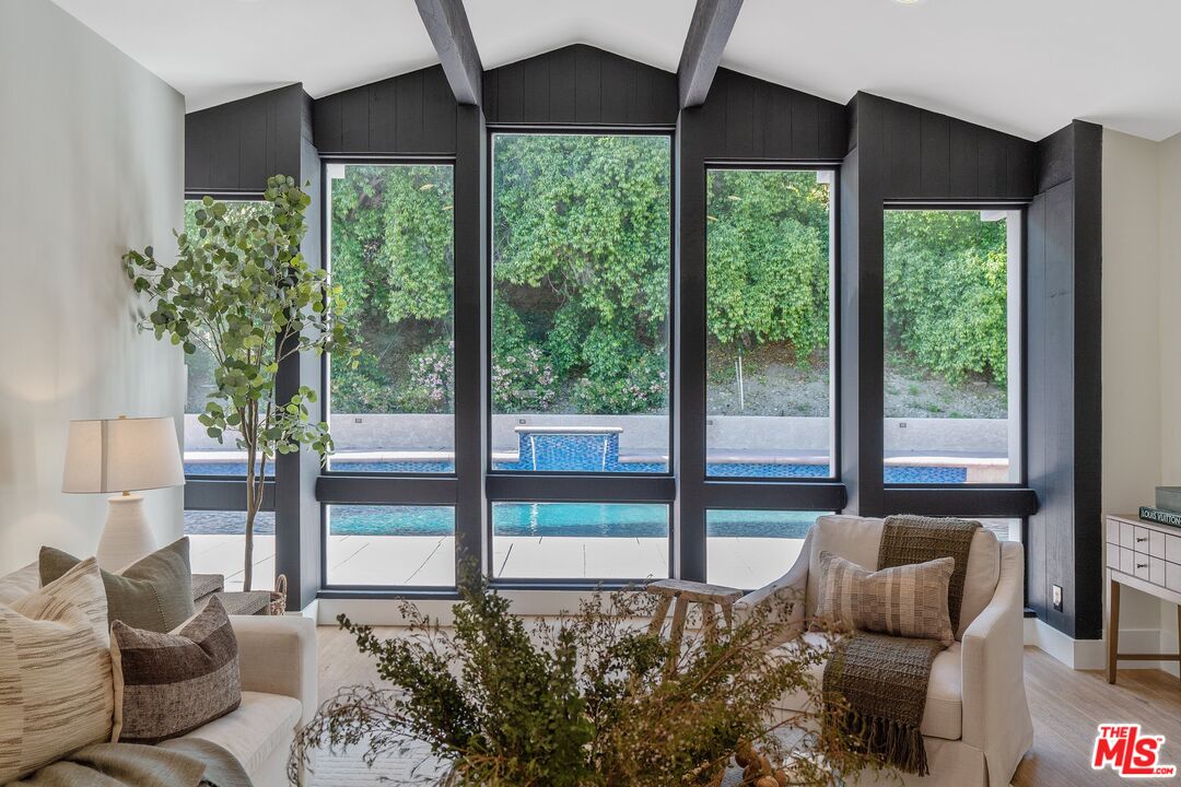 22801 Pera Road Woodland Hills, CA 91364 - Photo 6 of 46 a bedroom with furniture and a large window