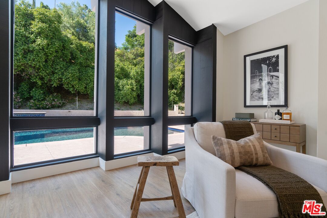 22801 Pera Road Woodland Hills, CA 91364 - Photo 8 of 46 a living room with furniture and a large window
