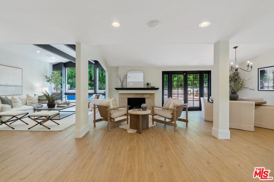 22801 Pera Road Woodland Hills, CA 91364 - Photo 9 of 46 a living room with fireplace furniture dining table and a fireplace