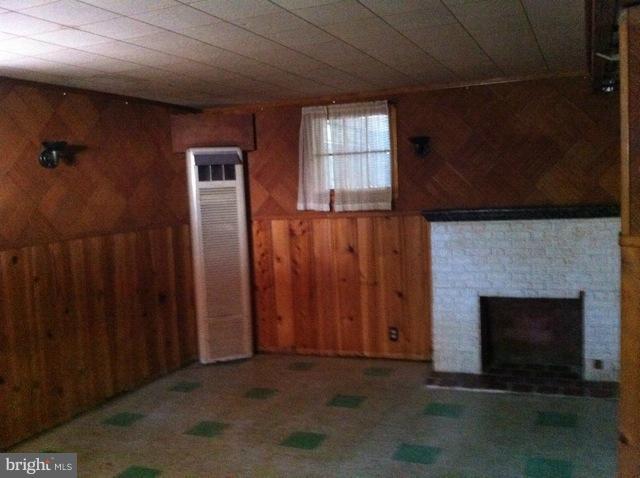 1305 Beatty Avenue Rosedale, MD 21237 - Photo 3 of 10 an empty room with windows and fireplace
