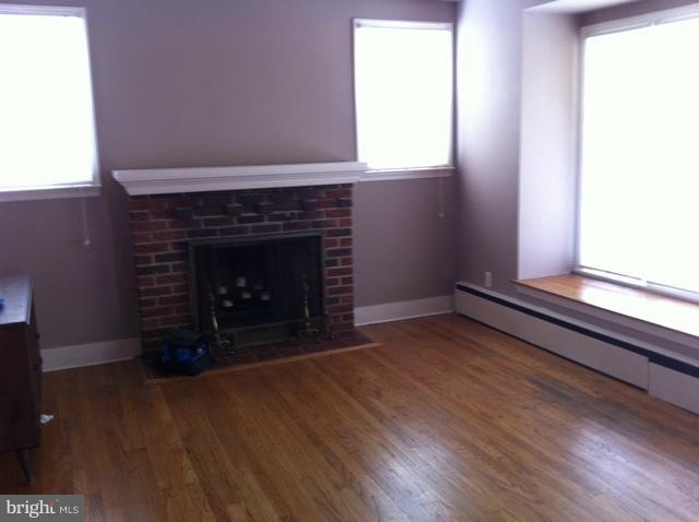 1305 Beatty Avenue Rosedale, MD 21237 - Photo 6 of 10 a living room with a fireplace and a wooden floor