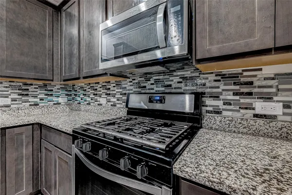 a kitchen with a stove and a microwave