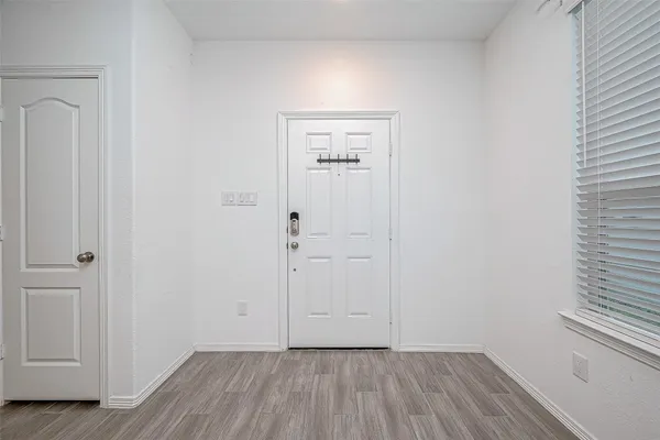 a view of a hallway with wooden floor