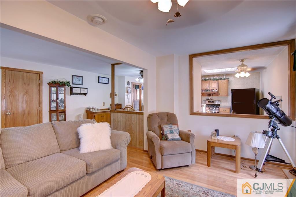60 Brookside Road Spotswood, NJ 08884 - Photo 14 of 34 a living room with furniture and a flat screen tv