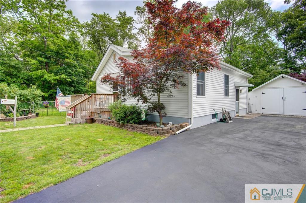 60 Brookside Road Spotswood, NJ 08884 - Photo 3 of 34 a view of a house with a yard and large tree