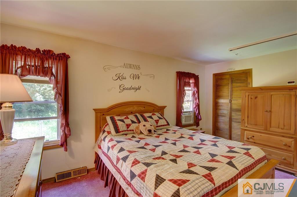 60 Brookside Road Spotswood, NJ 08884 - Photo 22 of 34 a bedroom with a large bed and a window