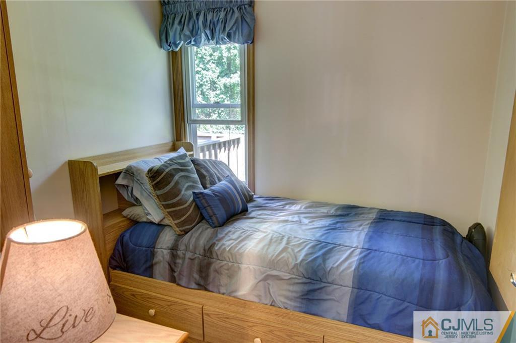 60 Brookside Road Spotswood, NJ 08884 - Photo 23 of 34 a bed sitting in a bedroom next to a window