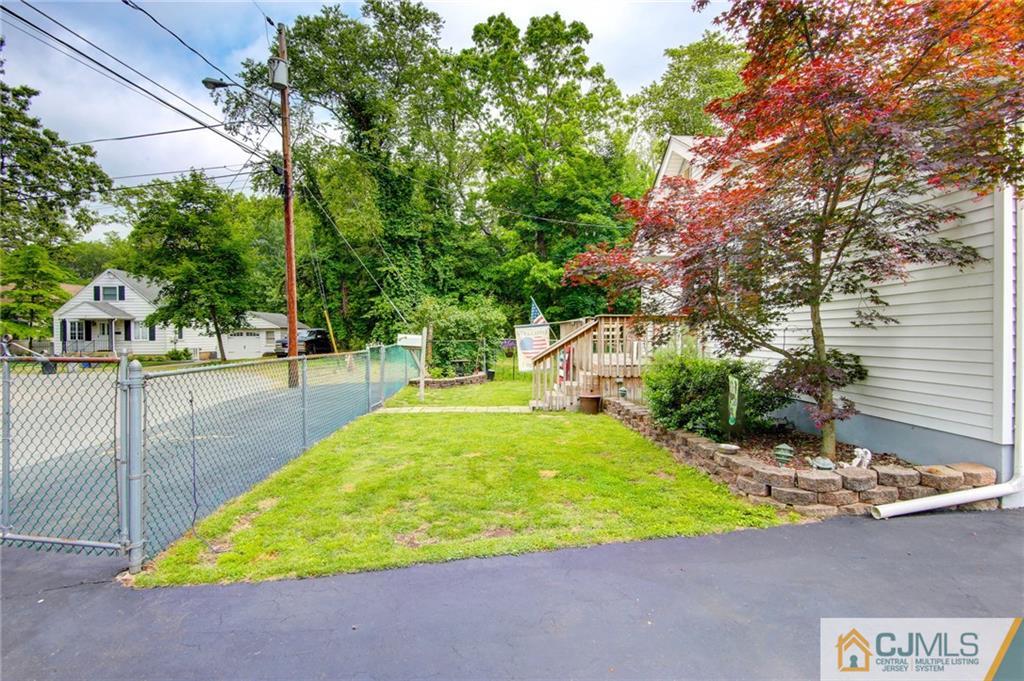 60 Brookside Road Spotswood, NJ 08884 - Photo 5 of 34 a view of a backyard with plants and trees