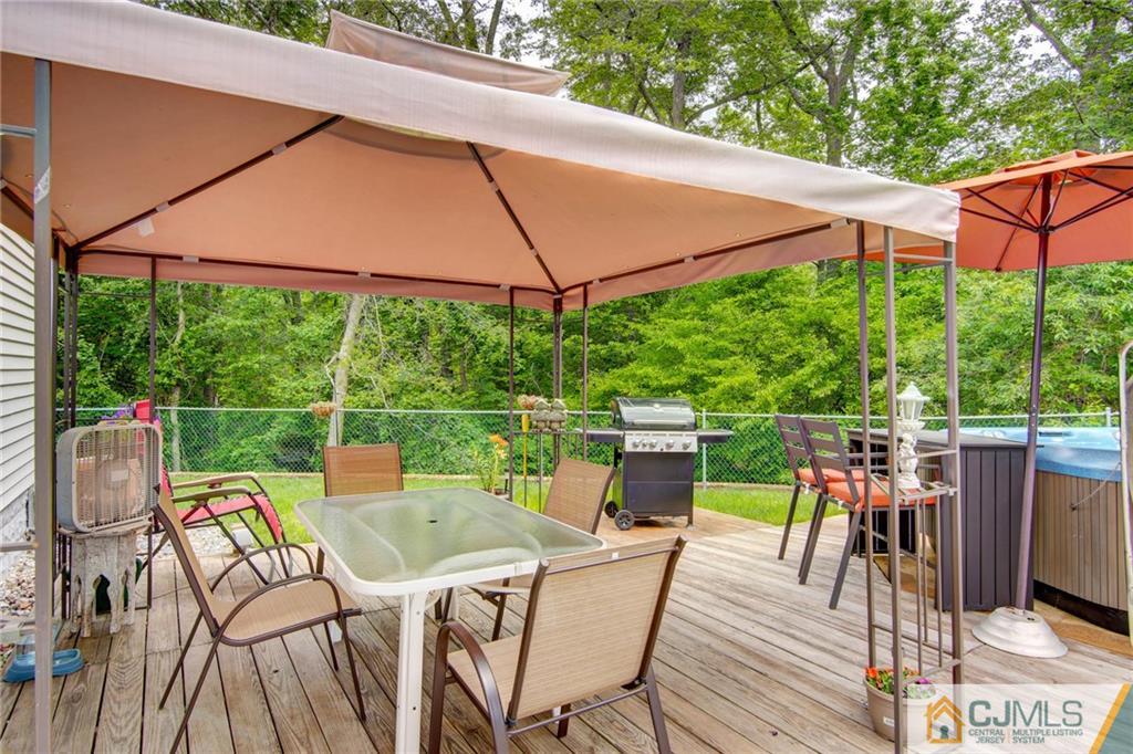 60 Brookside Road Spotswood, NJ 08884 - Photo 9 of 34 a view of a patio with table and chairs under an umbrella