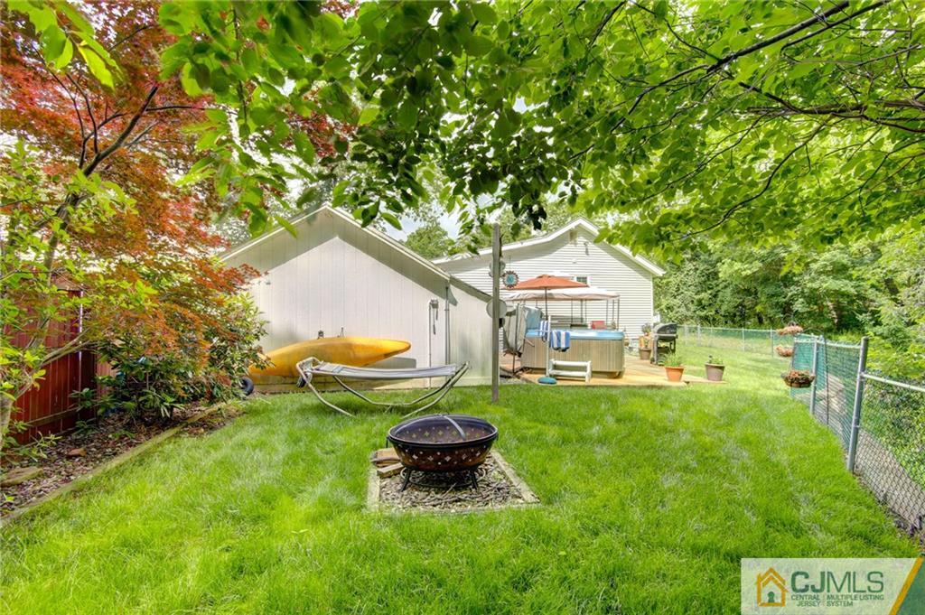 60 Brookside Road Spotswood, NJ 08884 - Photo 10 of 34 a swimming pool with outdoor seating and yard