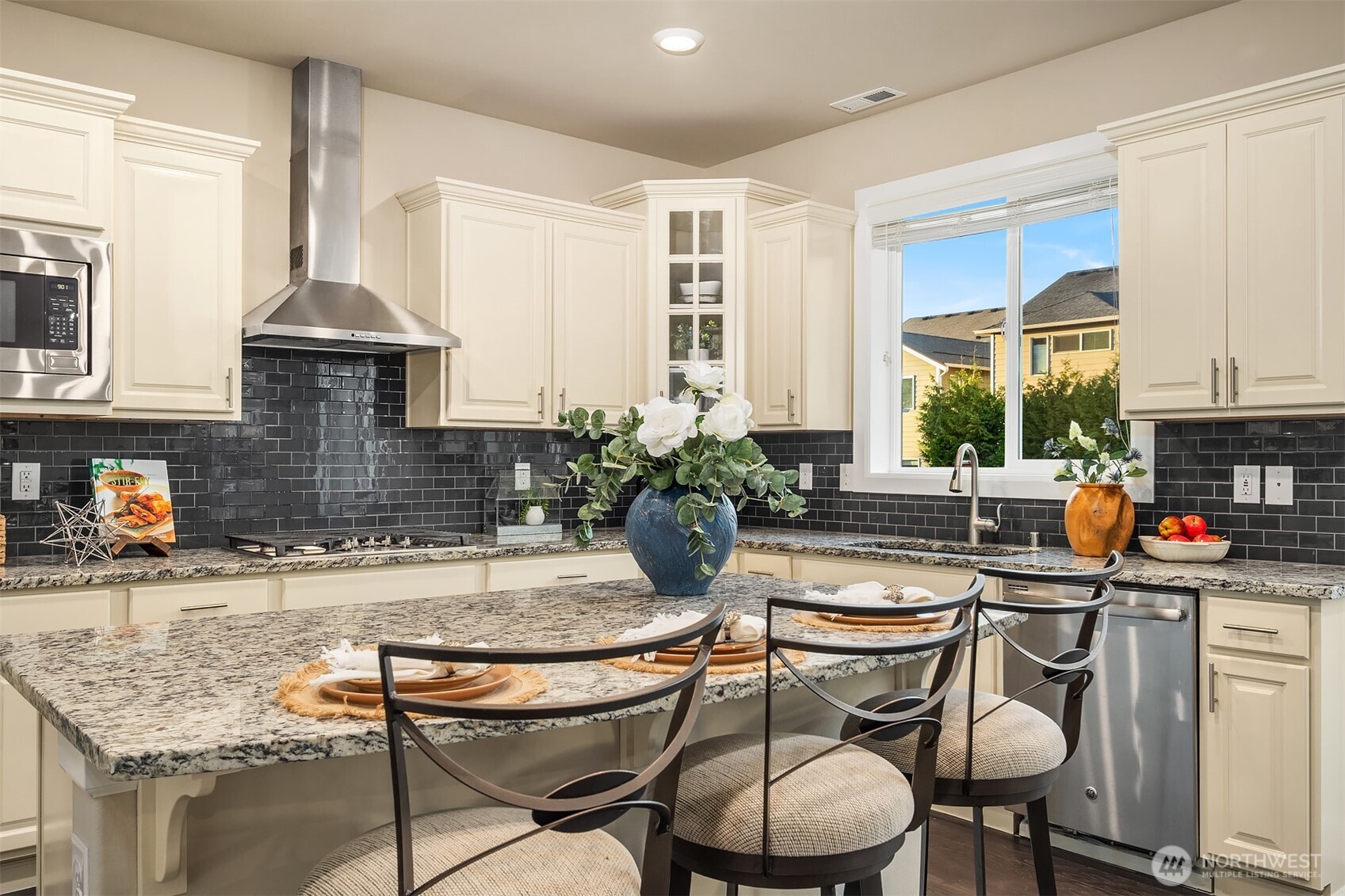 4111 174th Street Southeast Bothell, WA 98012 - Photo 12 of 40 a kitchen with granite countertop a sink chairs and cabinets