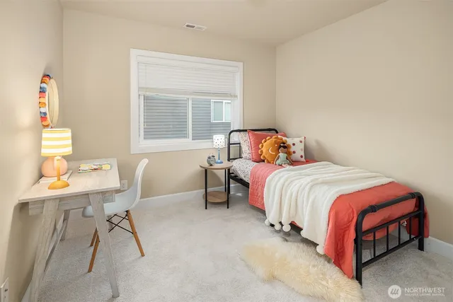 a bedroom with a bed and a table in it