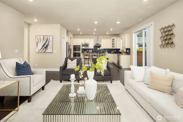 a living room with furniture and kitchen view