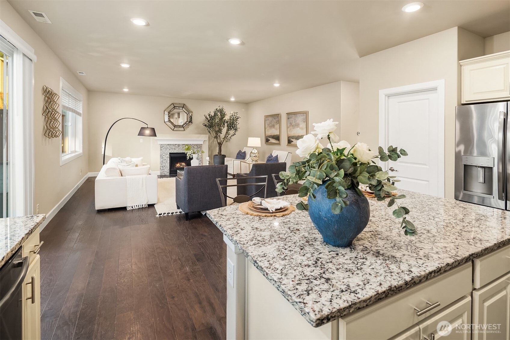 4111 174th Street Southeast Bothell, WA 98012 - Photo 10 of 40 a living room with furniture potted plant and a refrigerator