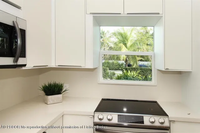 a kitchen with a stove and a white cabinet