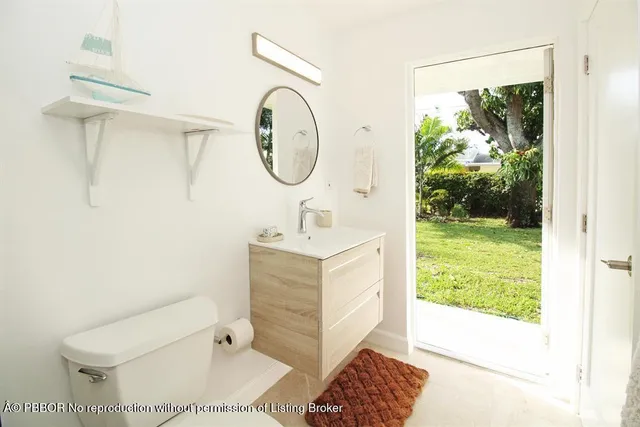 a bathroom with a sink toilet and a mirror