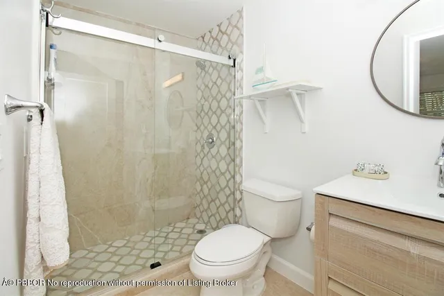 a white toilet sitting next to a bathroom sink