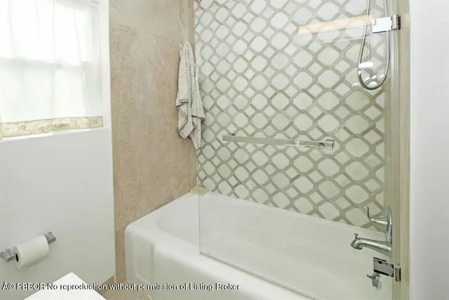 a bathroom with a bathtub and shower