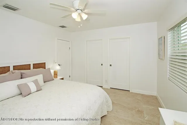 a spacious bedroom with a bed and a window