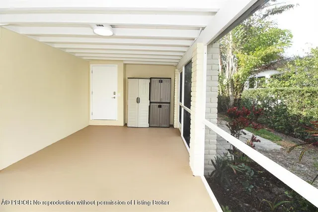 a view of a hallway with wooden floor and entryway